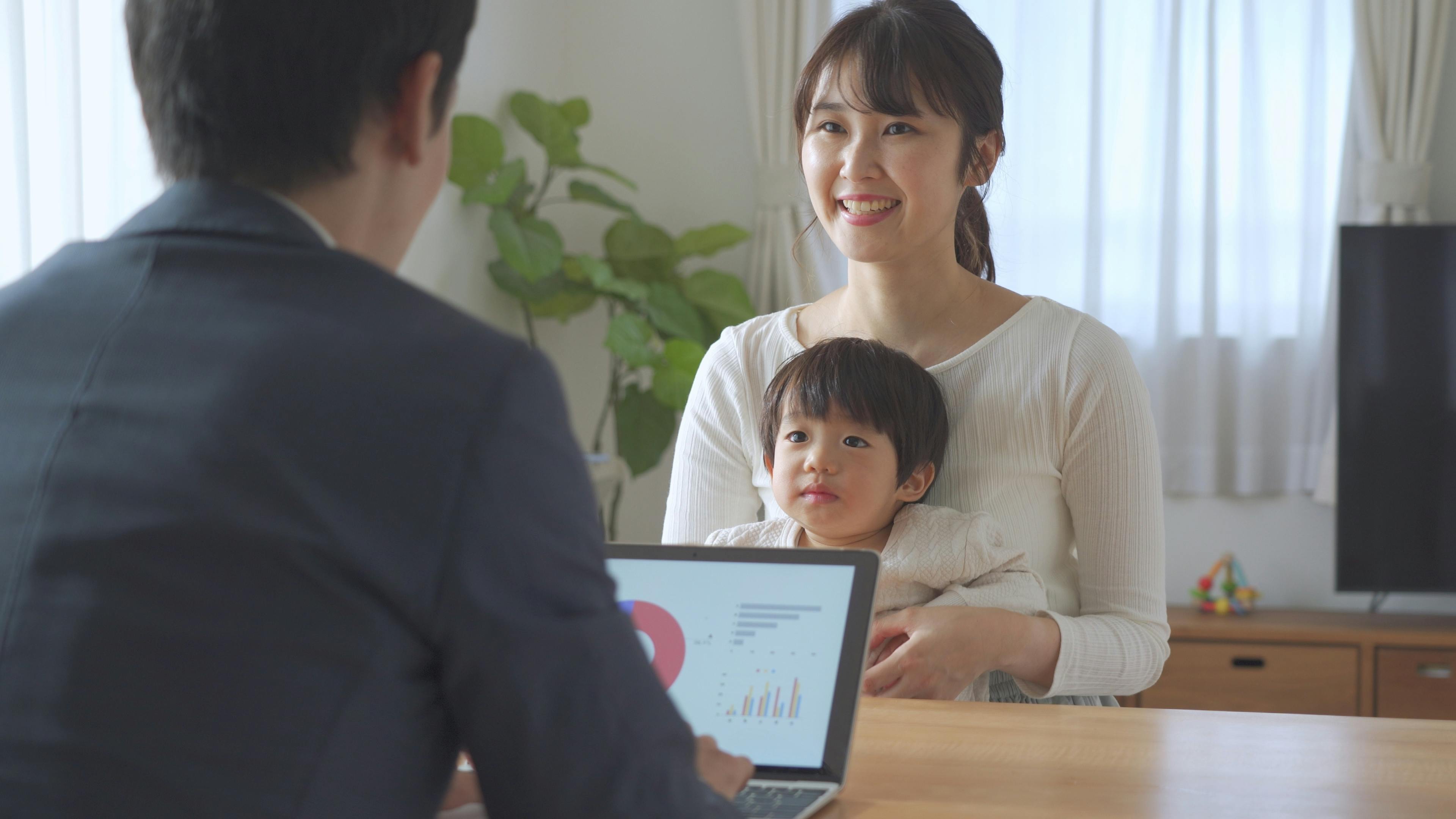 Une réunion familiale avec un homme d'affaires discutant avec une femme et son jeune enfant, probablement dans un contexte de consultation ou de planification familiale.